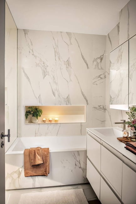 Small Bathroom with Integrated Tub and Lit Wall Niche