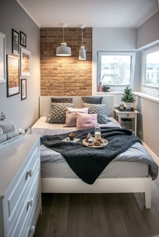 Small Bedroom Brick Accent Wall with Pendant Lights Over Bed