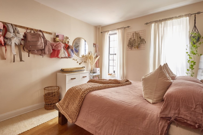 Small Bedroom Layout with Wooden Peg Rack Storage and Linen Bedding
