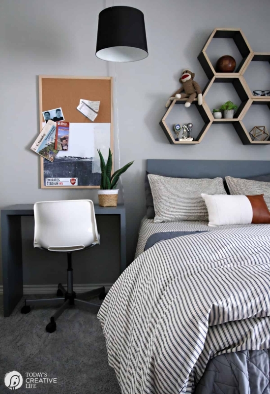 Small Bedroom with Hexagon Wall Shelves and Striped Bedding