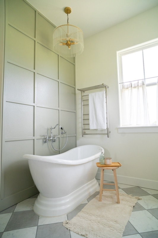 Soaking Bathtub with Sage Green Board and Batten Accent Wall