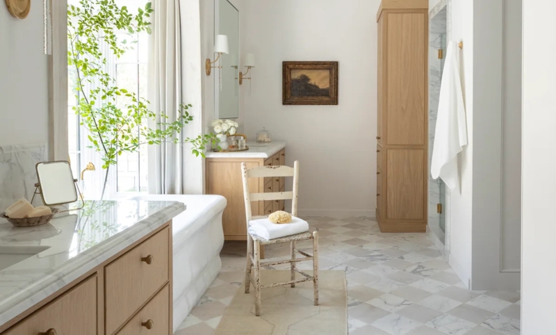 Soaking Tub with Diamond Marble Floor & Light Wood Vanity in Spa Bathroom