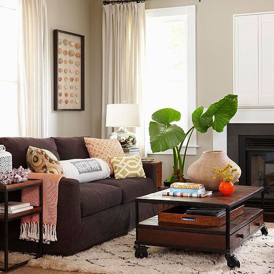 Sofa Chocolate Tone with Orange Accents and Industrial Coffee Table.