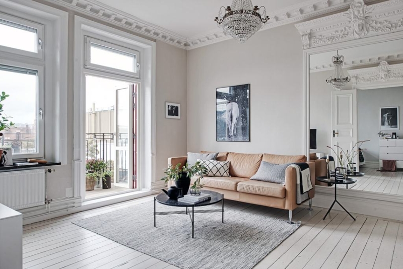 Sofa Tan Leather Like in Minimalist Room with Decorative Molding.