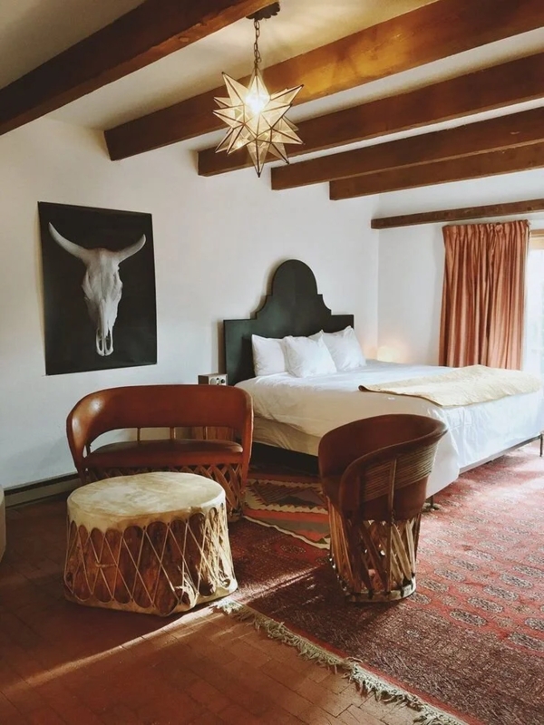 Southwestern Master Bedroom Design with Exposed Beams and Star Pendant
