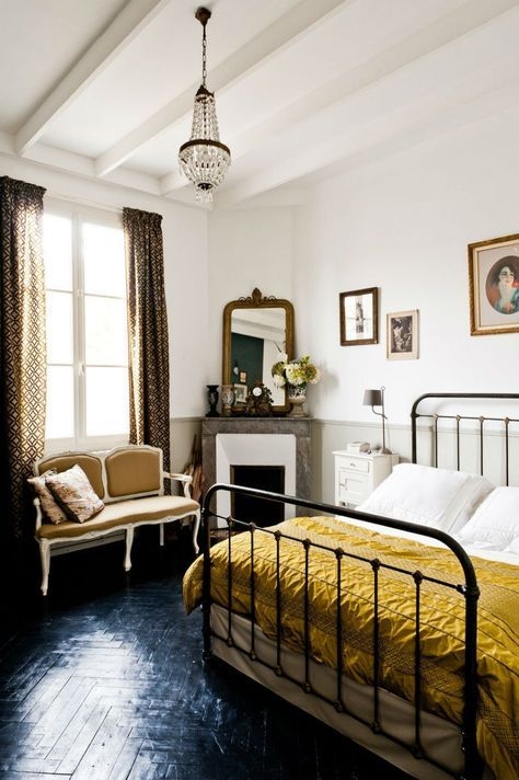 Spindle Bed Frame in Eclectic Bedroom with Fireplace and Herringbone