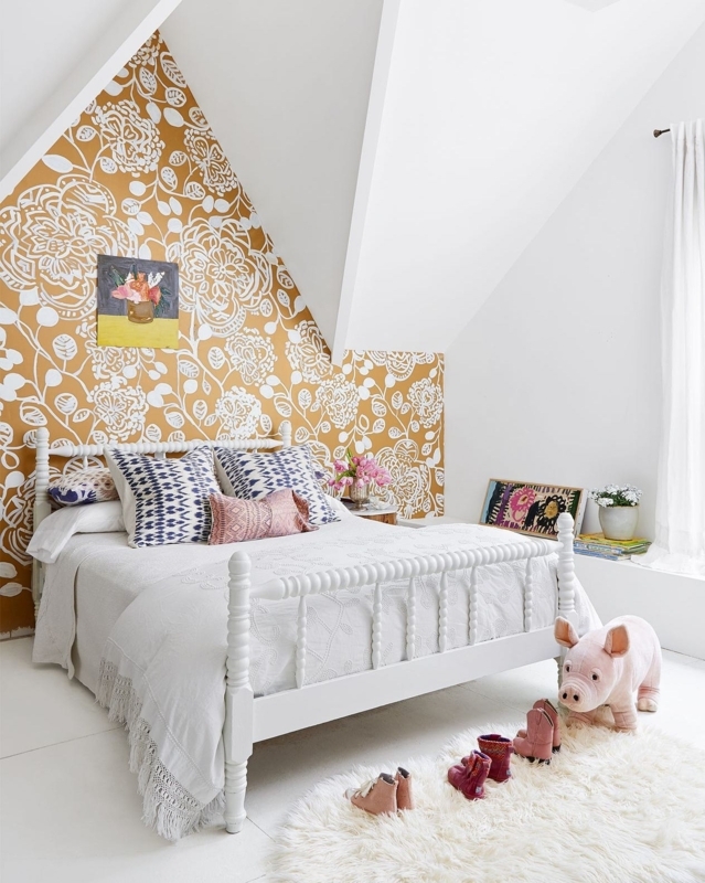 Spindle Bed in Attic Room with Ochre Floral Wallpaper Accent Wall