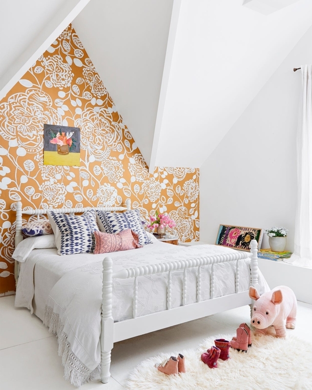 Spindle Bed in Whimsical Attic Bedroom with Sloped Ceilings