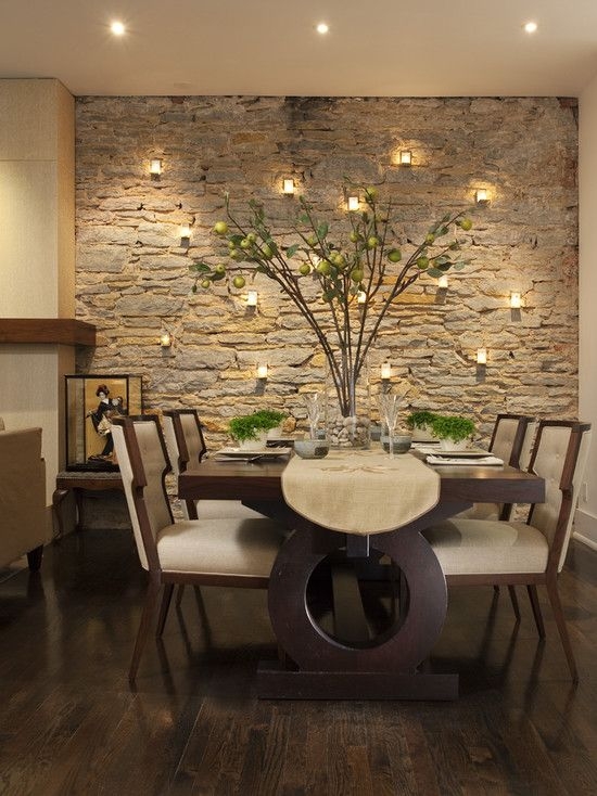 Stone Accent Wall Dining Room featuring Pedestal Table with Cutout
