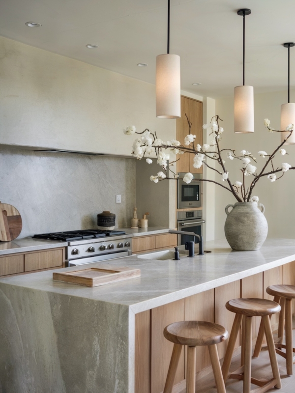 Stone Waterfall Island Countertop with Tripod Stools and Linen Pendants