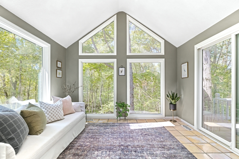 Sunroom: Geometric Window Wall Design and Sage Green Walls