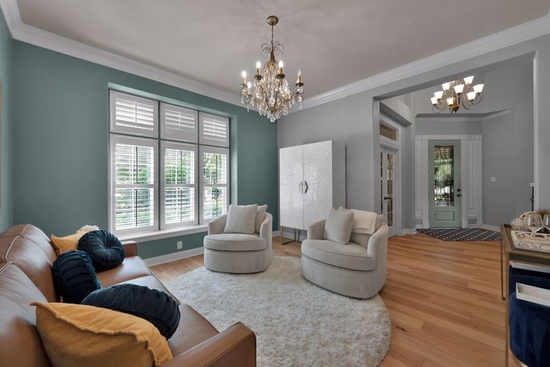 Swivel Chairs in Teal Accent Wall Living Room with Plush Round Rug