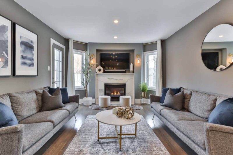 Symmetrical Living Room Layout with Facing Sofas and Marble Fireplace