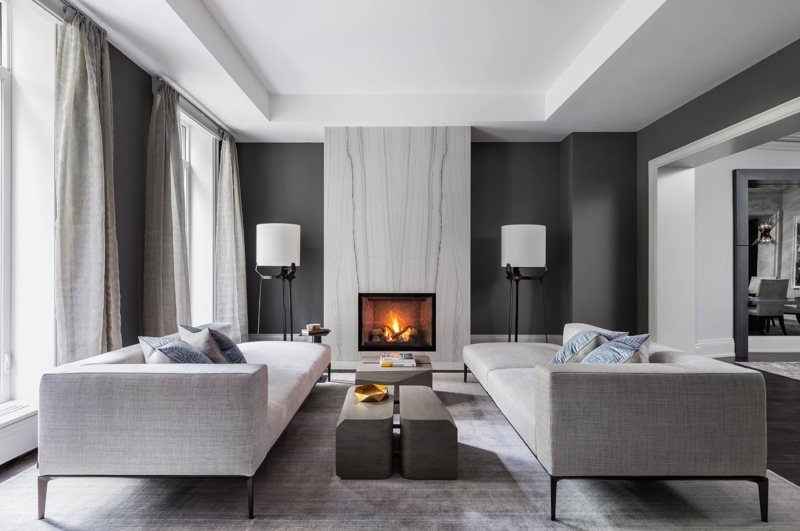 Symmetrical Living Room with Twin Sofas and Tall Stone Fireplace