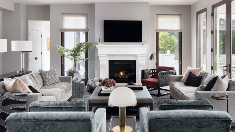 Symmetrical Sofa Arrangement with TV Above Fireplace & Chairs