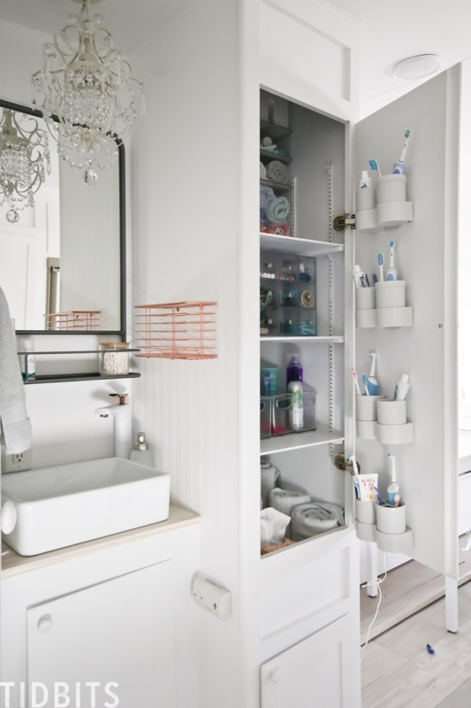 Tall White Linen Cabinet with Door Bins and Beadboard in Tiny Home Bath