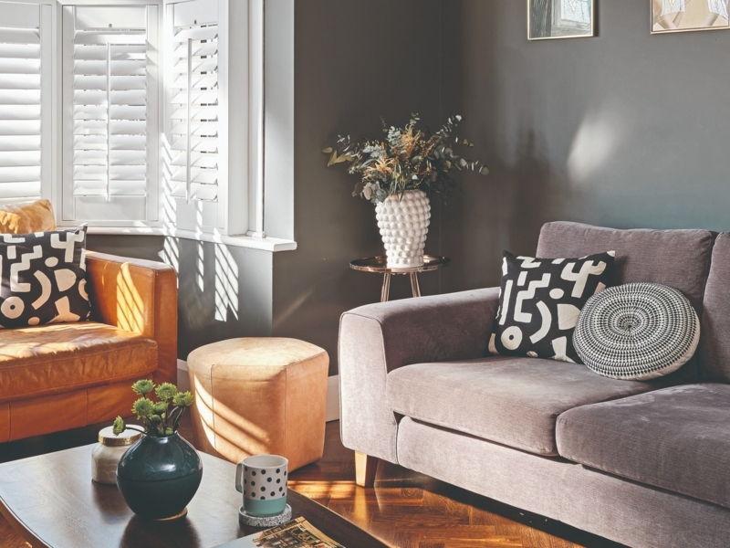 Tan Leather Accent Chair and White Shutters in Living Room Decor