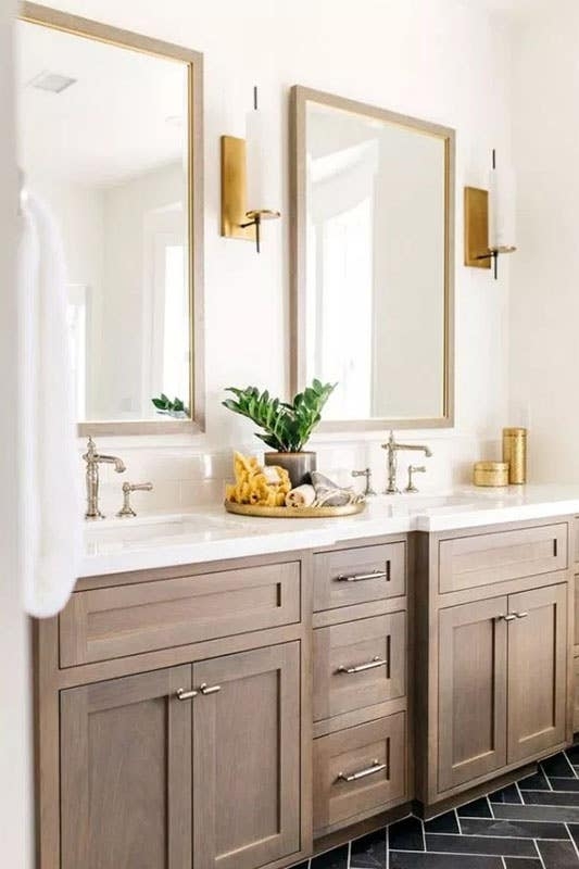 Taupe Double Vanity with Herringbone Floor & Gold Mirrors