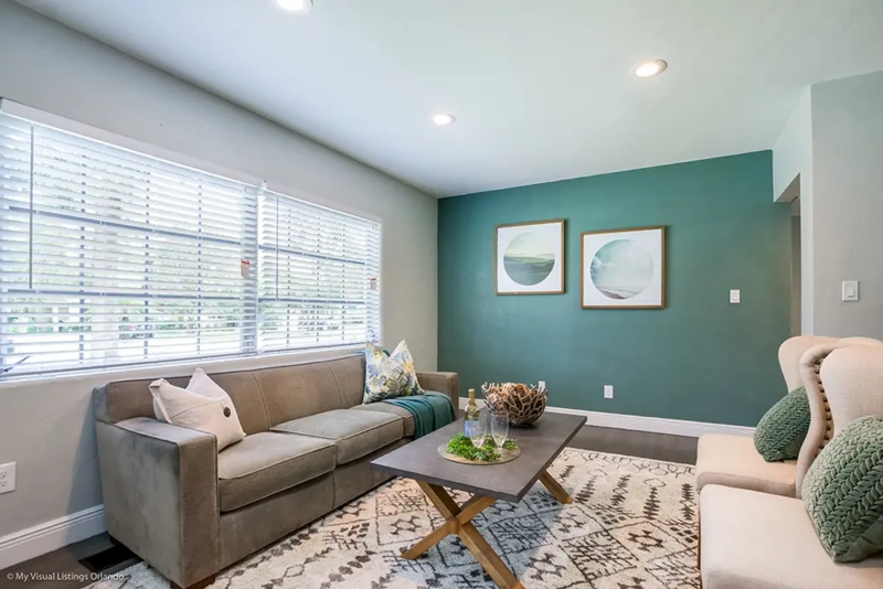 Teal Accent Wall Living Room: Wingback Chairs with Nailheads