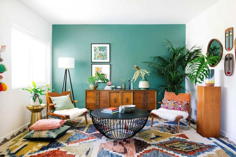 Teal Accent Wall Living Room with Geometric Rug and Wire Base Table