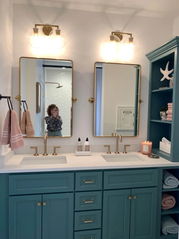 Teal Double Vanity with Gold Faucets and Built-In Shelving