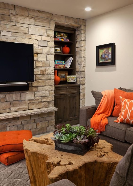 Textural Living Room with Stacked Stone Wall and Natural Wood Stump Table
