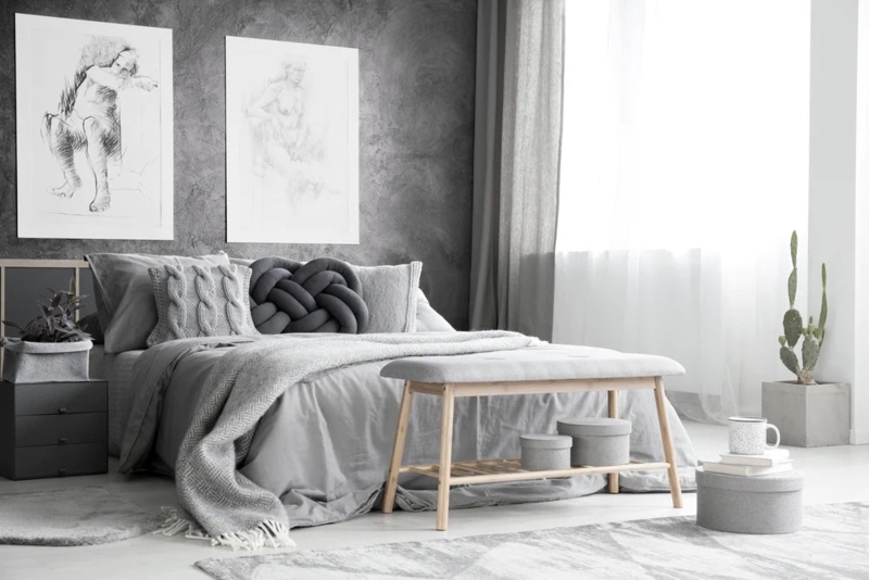 Textured Accent Wall Bedroom: Monochromatic Design with Knot Pillow