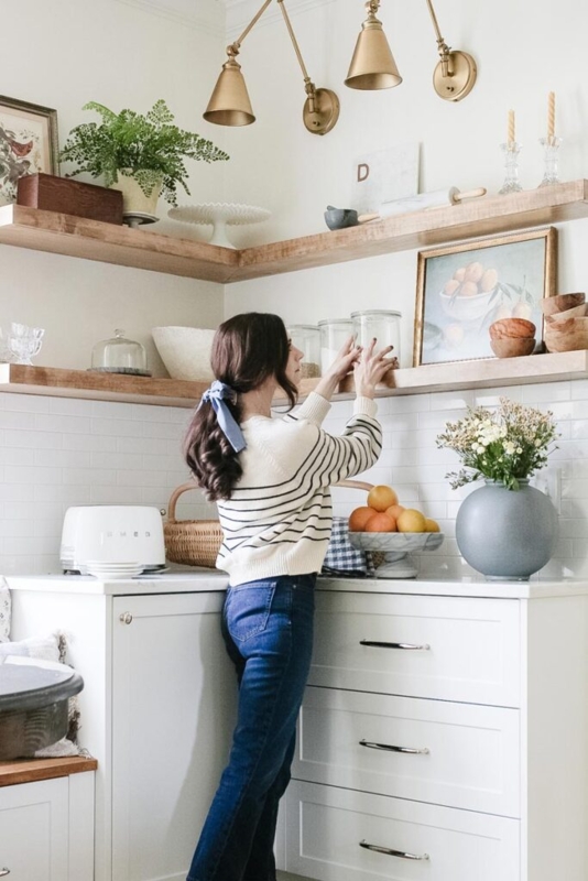 Thick Floating Shelves in a Bright Kitchen with Brass Swing Arm Sconce