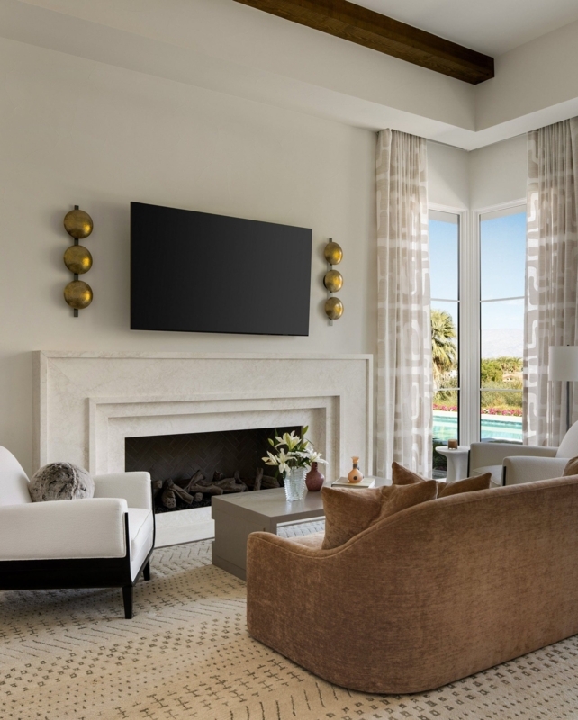 Tiered Stone Fireplace Mantel & Gold Disc Wall Decor