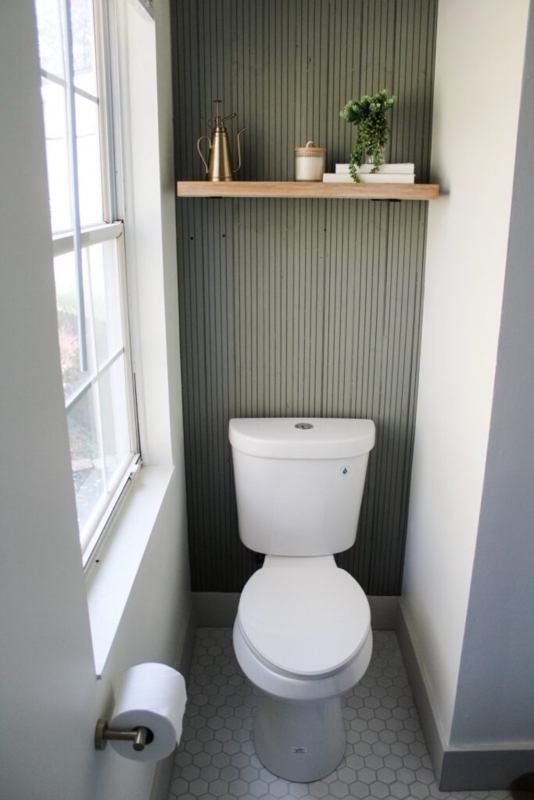 Toilet with Sage Green Ribbed Accent Wall & Floating Shelf