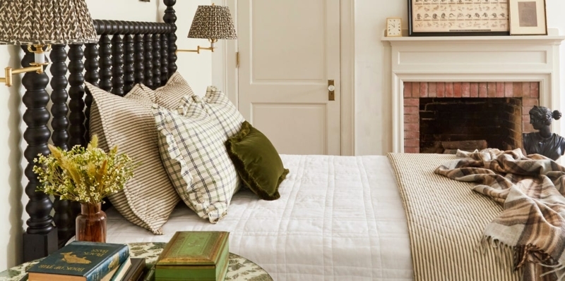 Traditional Bed Styling with Black Bobbin Headboard near Brick Fireplace
