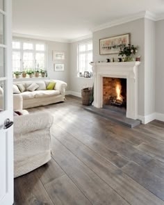 Traditional Grey Wood Floor Living Room with White Fireplace Mantle