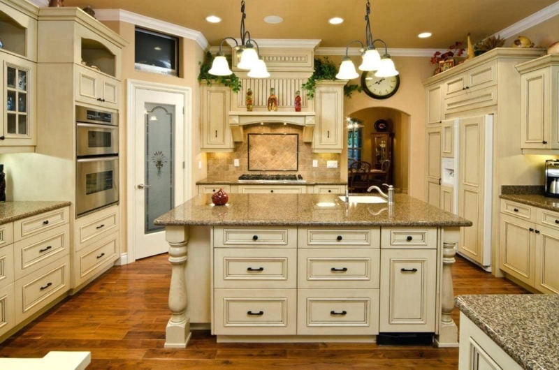 Traditional Kitchen with Cream Glazed Cabinetry and Ornate Range Hood