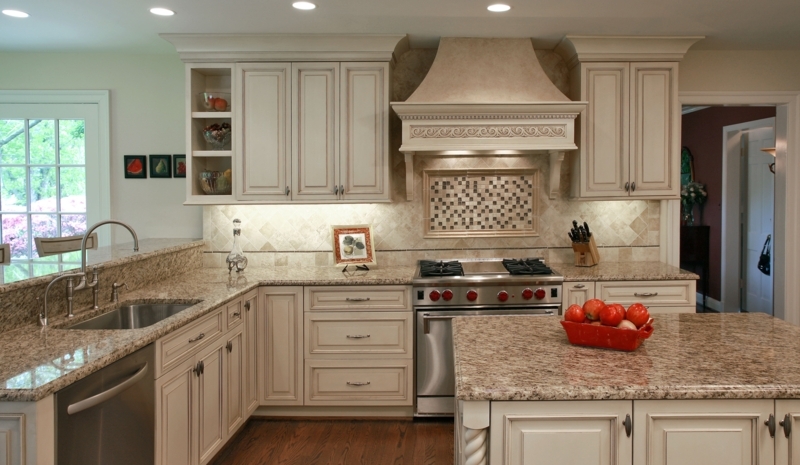 Traditional Kitchen with Cream Glazed Cabinetry and Ornate Range Hood