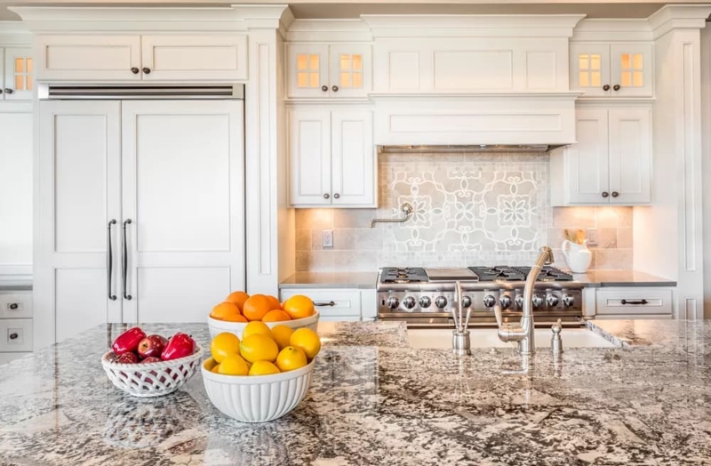 Traditional Kitchen with Speckled Granite Island and Medallion Tile