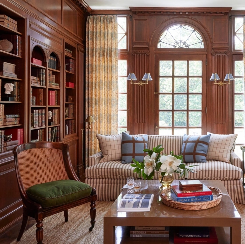 Traditional Library Living Room with Wood Paneling and Striped Sofa
