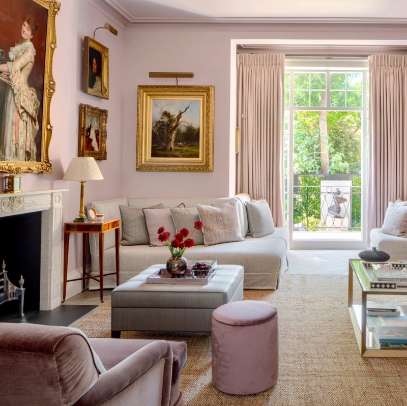 Traditional Living Room with Pink Walls and Stacked Gilded Art
