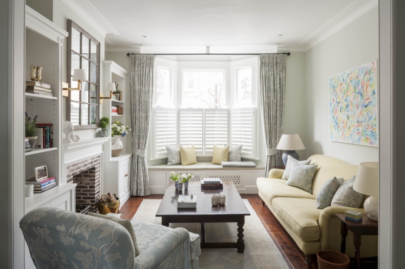 Traditional Living Room with Plantation Shutters and Pale Yellow Sofa