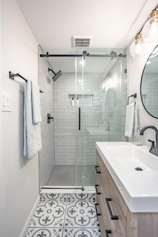Transitional Bathroom Design with Patterned Floor Tile & Wood Vanity