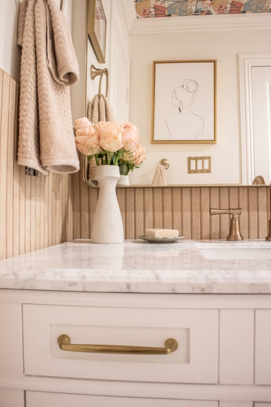Transitional Bathroom Vanity with marble top and floral ceiling wallpaper.