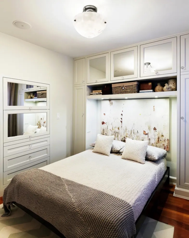 Transitional Bridge Cabinetry Over Bed With Mirrored Upper Cabinets