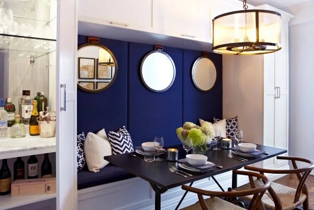 Transitional Dining Nook: Navy Blue Built-in Banquette & Round Mirrors