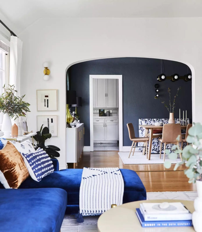 Transitional Dining Room with Arched Doorway & Blue Accent Wall