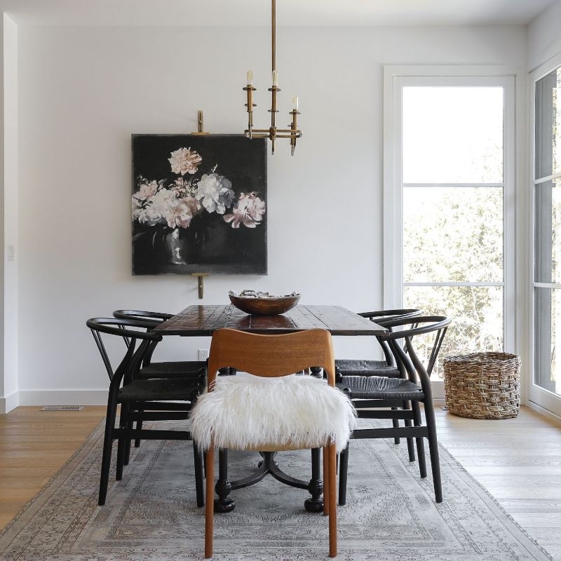 Transitional Dining Room with Black Wishbone Chairs and Faux Fur