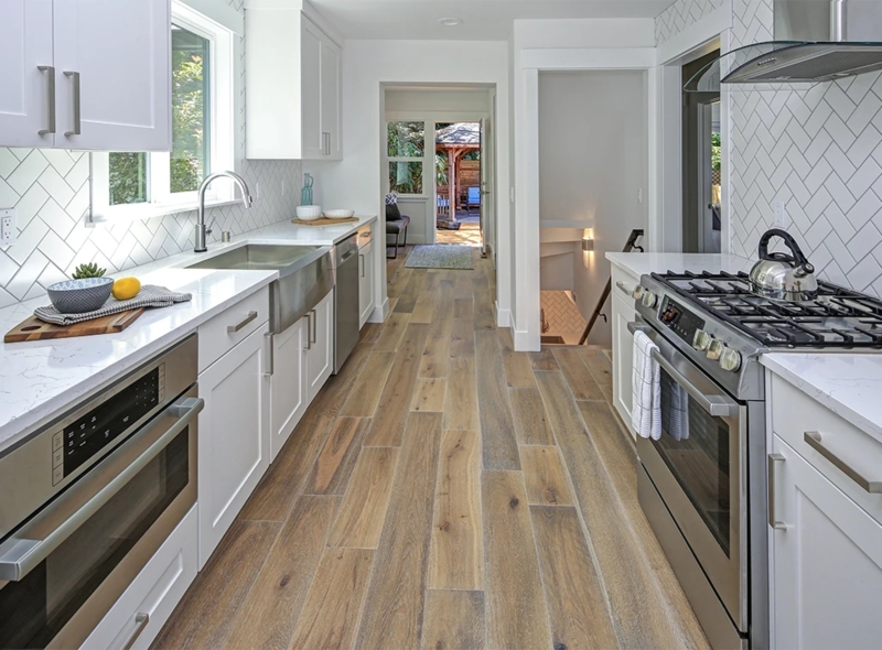 Transitional Galley Kitchen with Wood Plank Flooring and Herringbone Tile