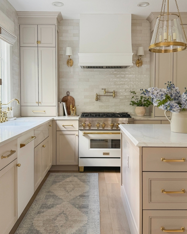 Transitional Greige Cabinetry with White & Gold Range & Pot Filler