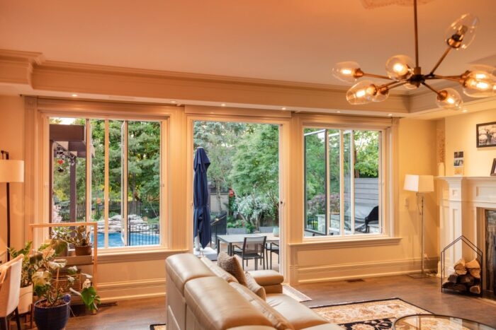Transitional Living Room with Indoor Outdoor Flow and Globe Chandelier