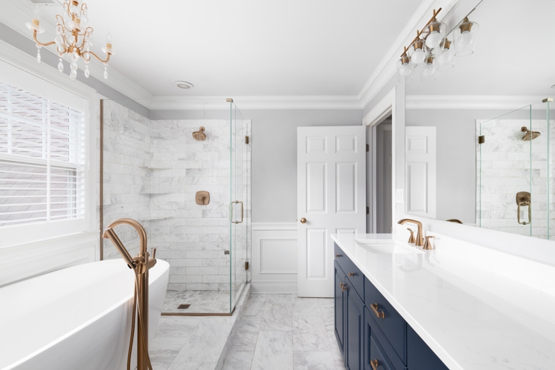 Transitional Luxury Bathroom: Navy Blue Vanity And Gold Fixtures Design