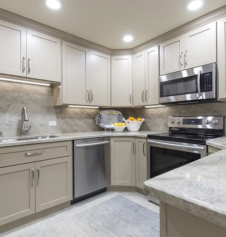 Transitional Taupe Kitchen with Full Stone Backsplash and Lighting.