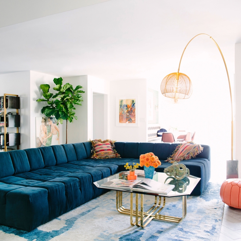 Tufted Blue Sectional Sofa with Arched Mesh Lamp and Geometric Table